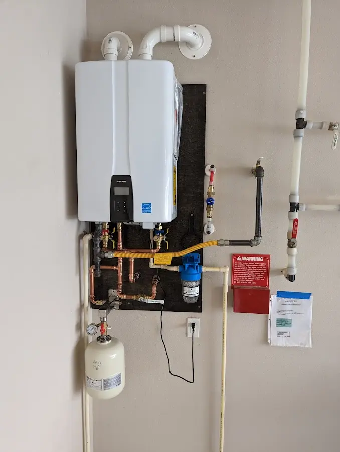 Professional plumber installing copper piping in a Ada home